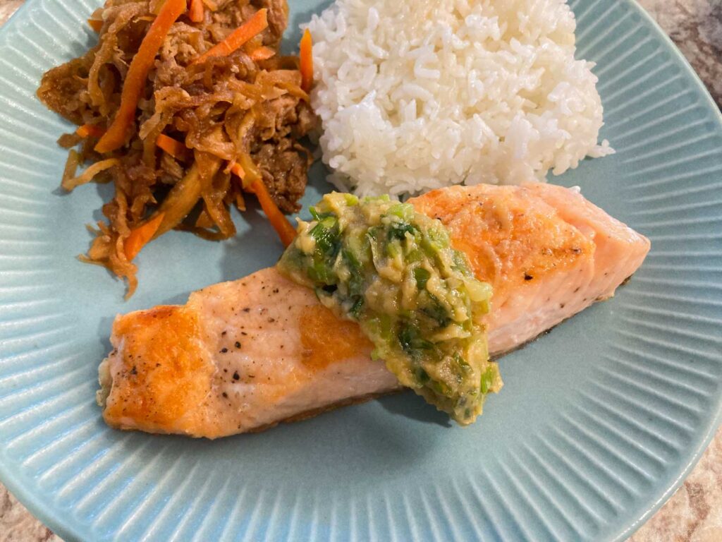 simmered kiriboshi daikon, rice, and baked salmon with miso butter scallion sauce on top