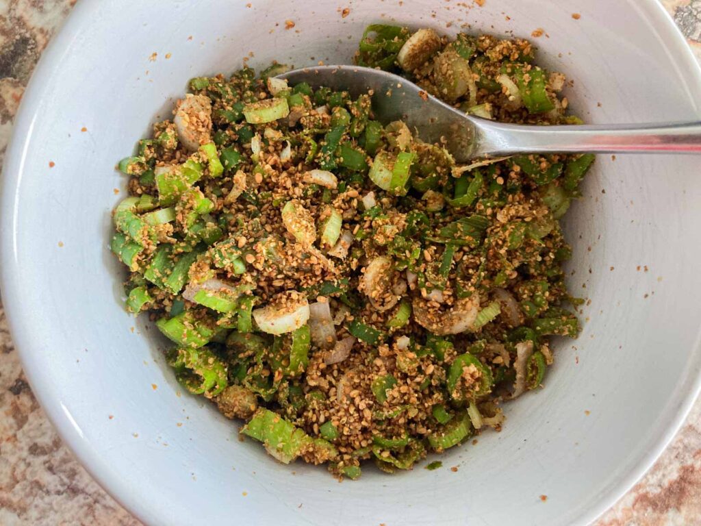 ground sesame and minced scallions are mixed in a bowl