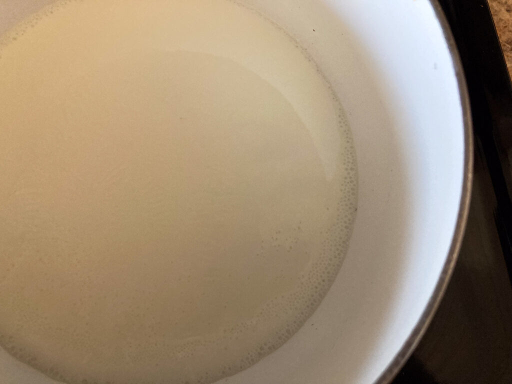 milk is warmed up in a pot