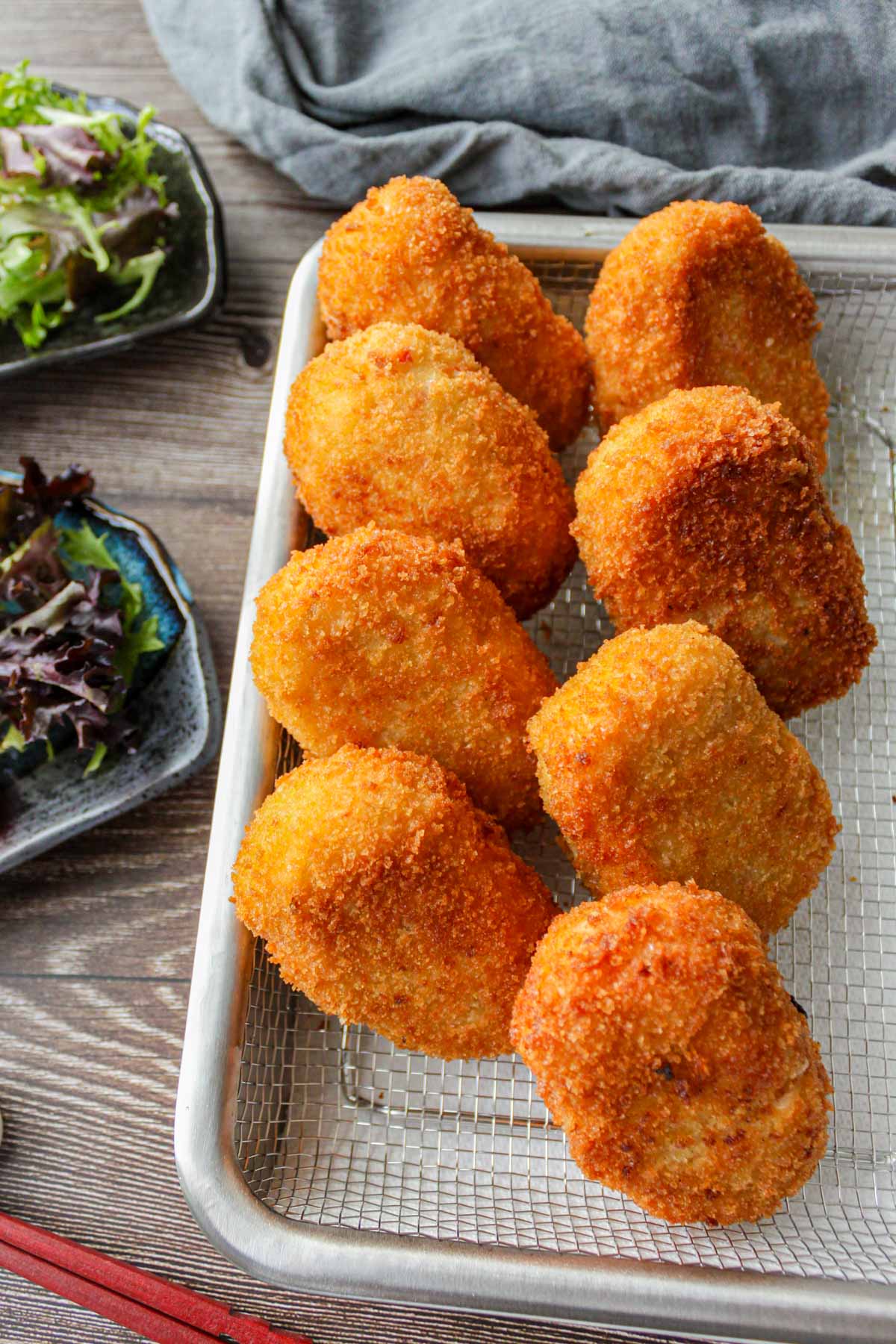 eight creamy crab croquettes on a cooking rack