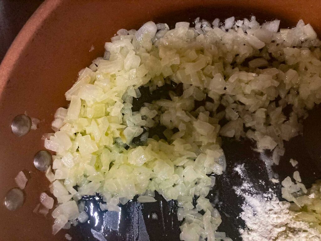 minced onions are fried in a pan