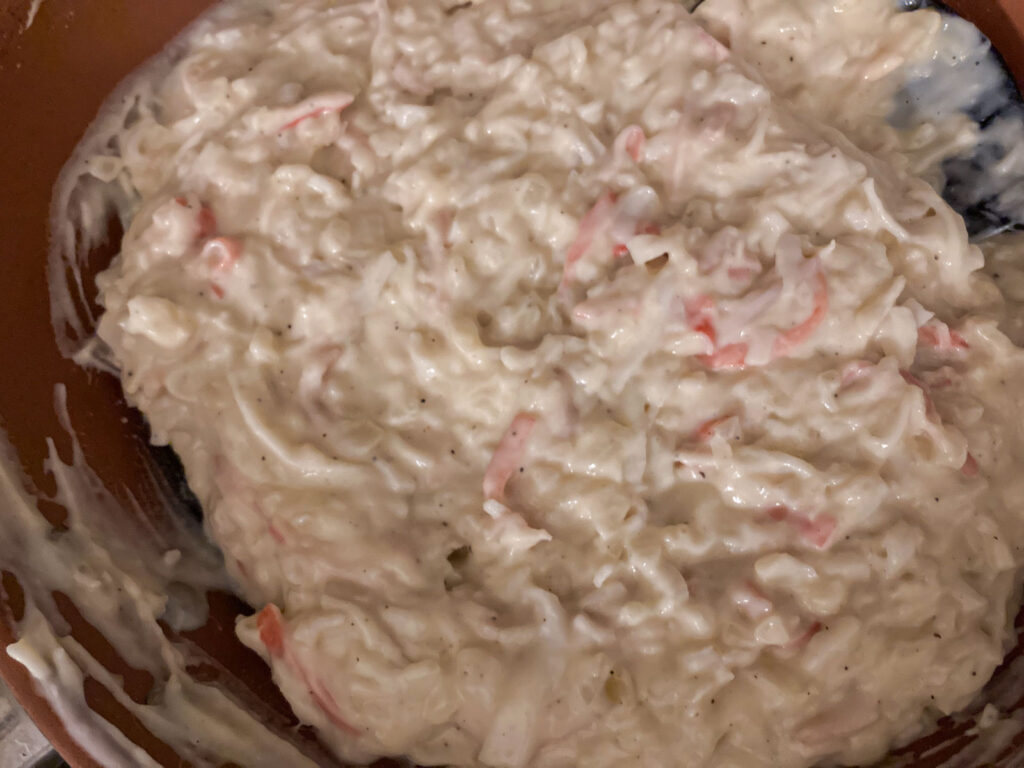 white sauce with crab meat in a pan