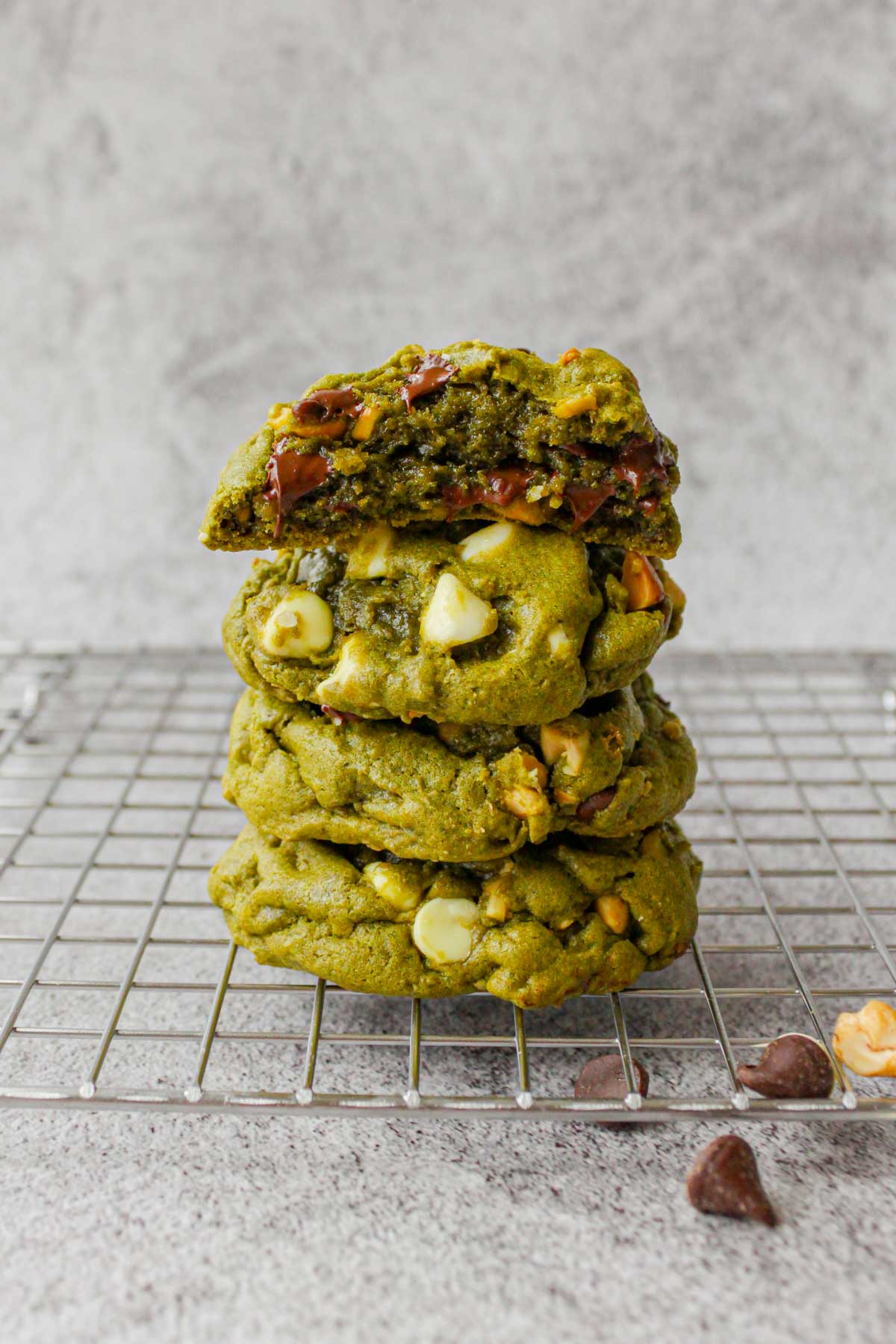 stacked matcha chocolate chip cookies on a cooling rack