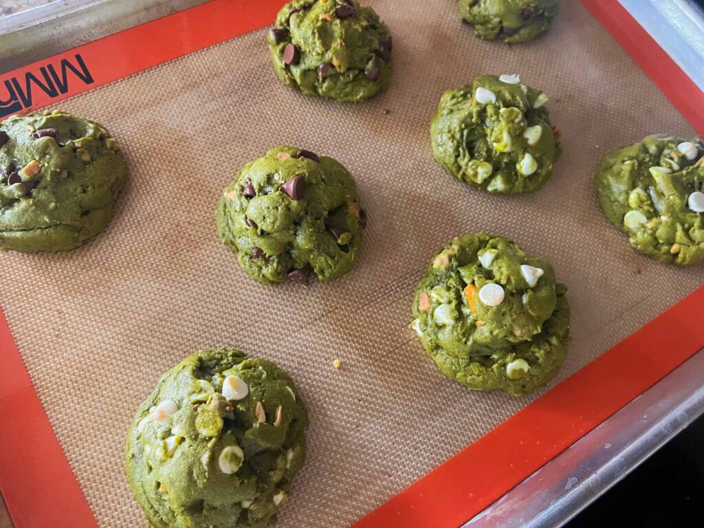 baked matcha chocolate chip cookies on a baking sheet