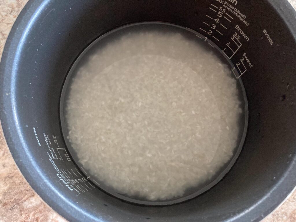 rice is soaked in water in a rice cooker