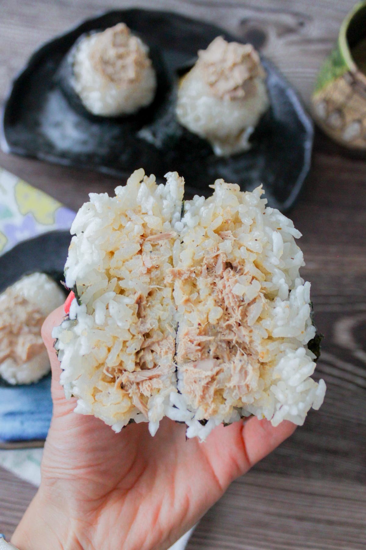 Two tuna mayo onigiri on a plate.