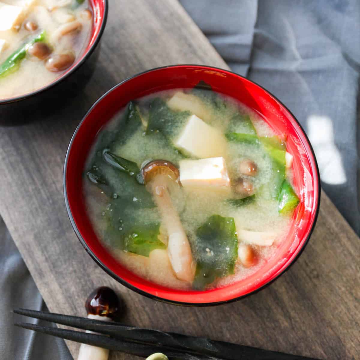 miso soup with shimeji, tofu, and wakame in a bowl.