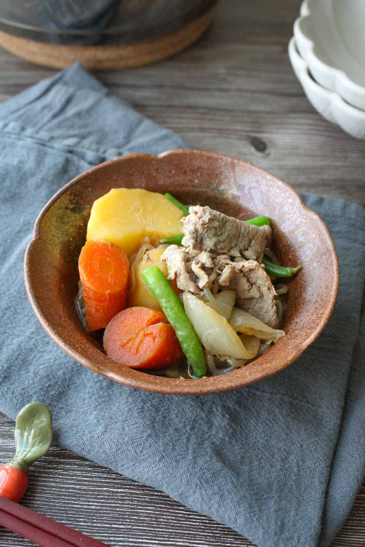 Nikujaga in a brown bowl.