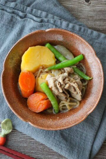Nikujaga in a brown bowl.