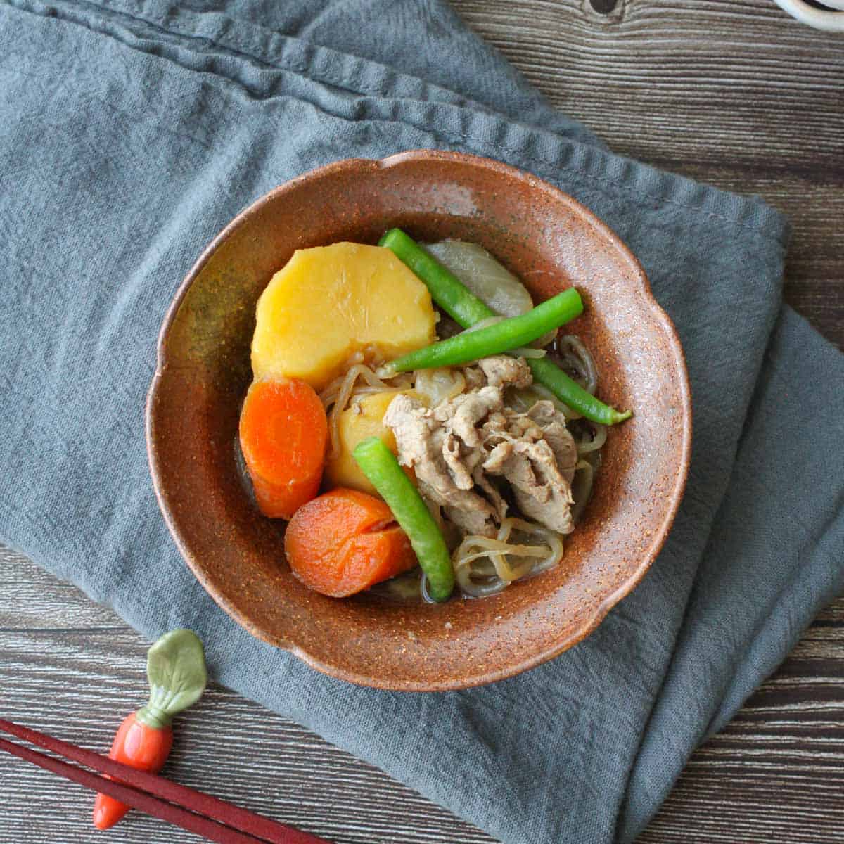 Nikujaga in a brown bowl.