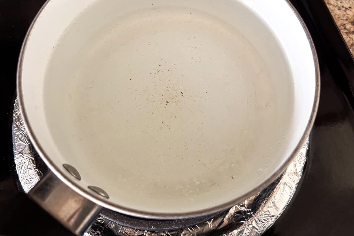 Heat water in a pot until right before it starts boiling.