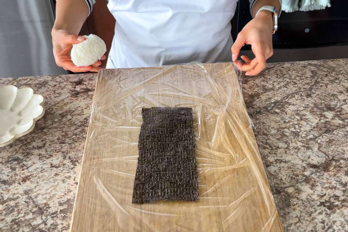 Place nori on plastic wrap.