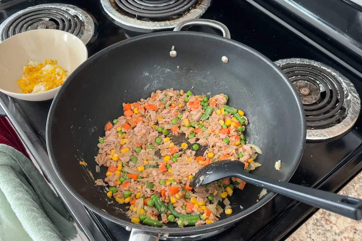 Add canned tuna, natto, and frozen mixed veggies and fry.