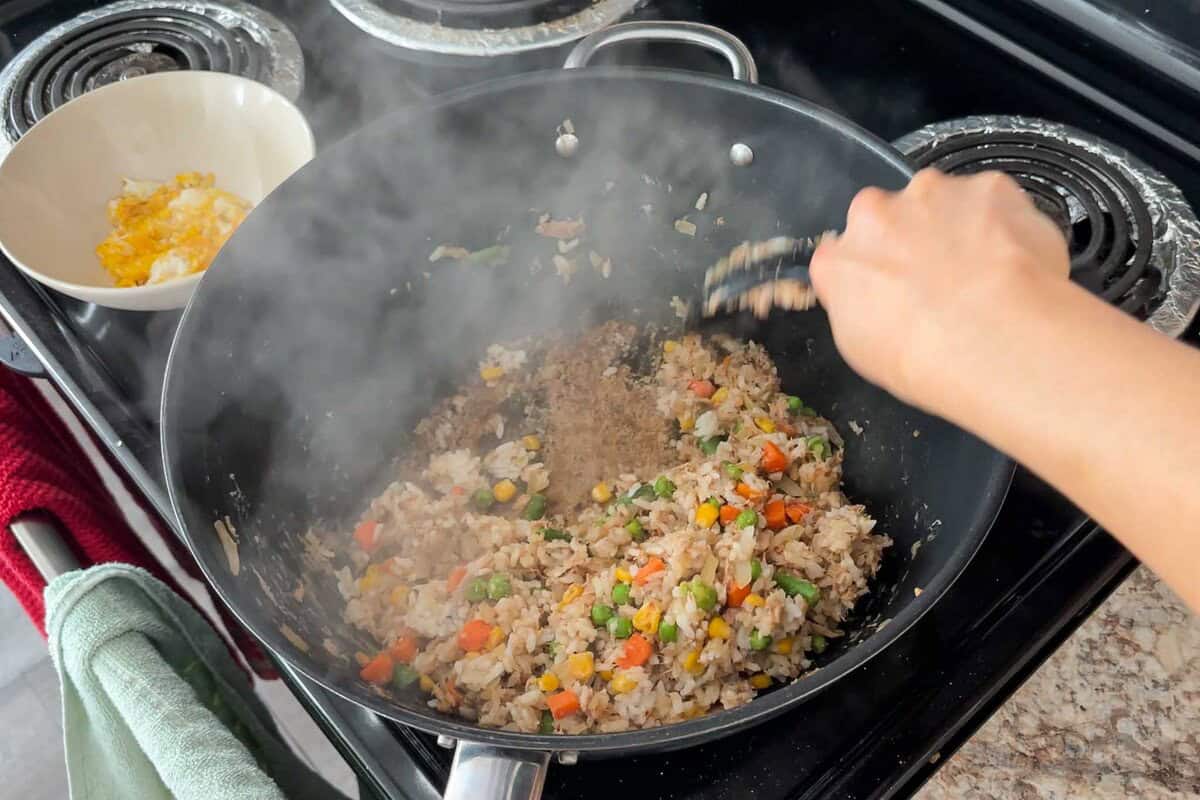 Add cooked rice and garlic paste and mix everything together.