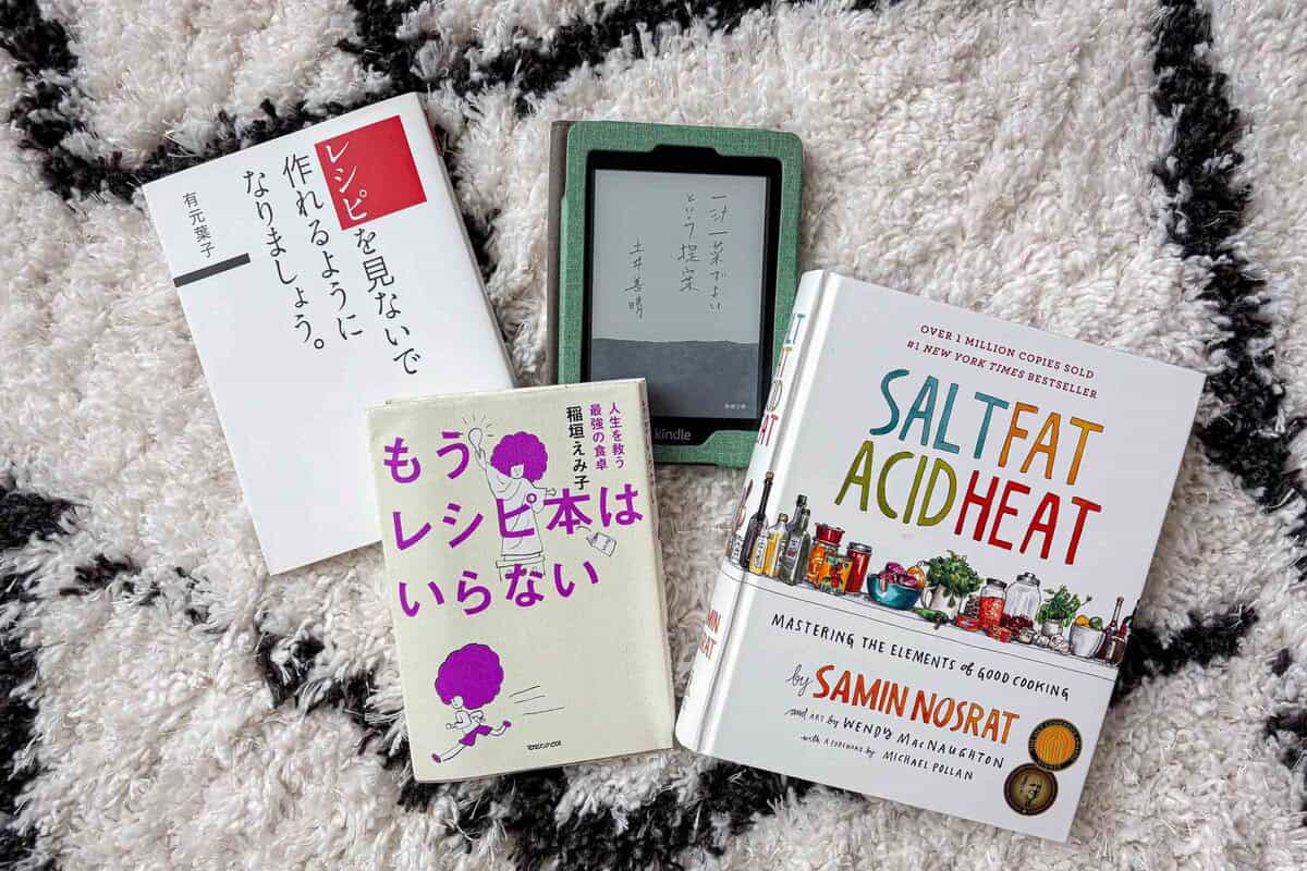 Four books on a carpet.